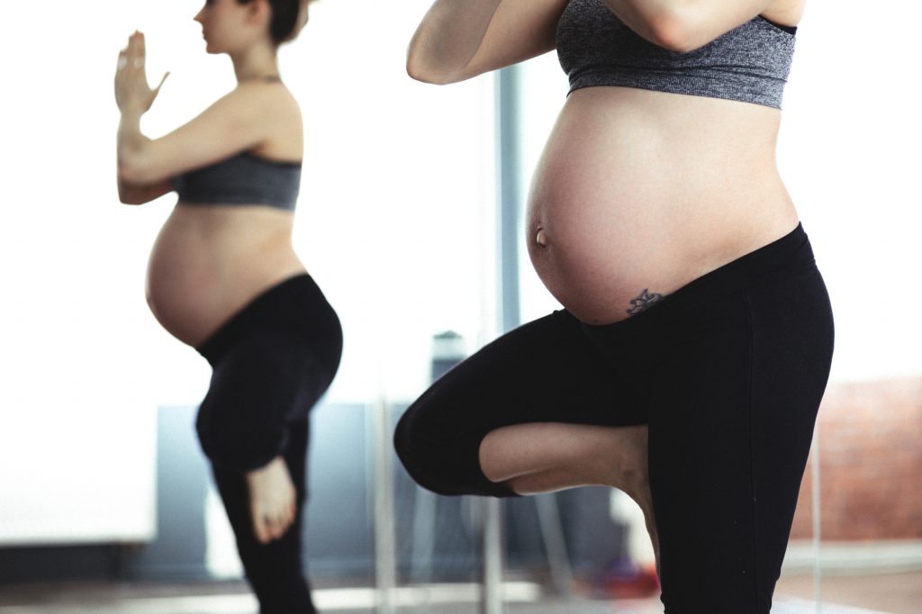 Fit pregnant woman doing yoga